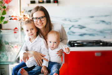 Caucasian mother in glasses and two children sons