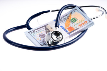 Stethoscope and banknote with white background
