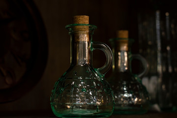 Glass vessels under olive oil. Front view, Served table.