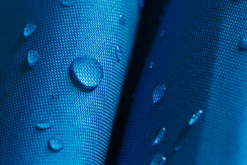 Water droplets on a  waterproof fabric  blue background