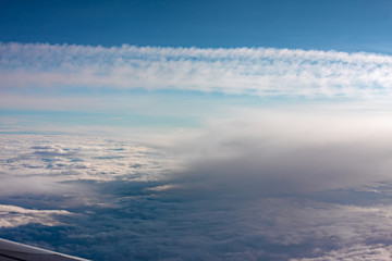 Naklejka na ściany i meble A carpet of clouds seen from the window of an airliner.
