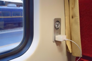 Soft focus on Reading light and AC power outlet 220V  for passengers on the train