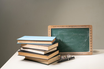 Book and green board with educational concept