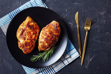 Two chicken breasts roasted in spices, top view