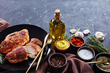 Spicy chicken fillets with rosemary and cutlery