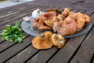 Plate of appetizing mushrooms accompanied by vegetables with garlic