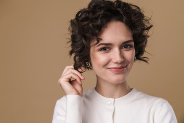 Image of joyful young woman smiling and looking at camera