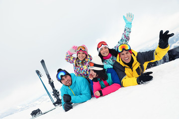 Group of friends with equipment in snowy mountains. Winter vacation