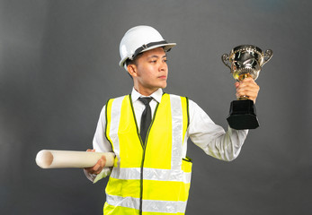 Cpnstruction worker holding trophy