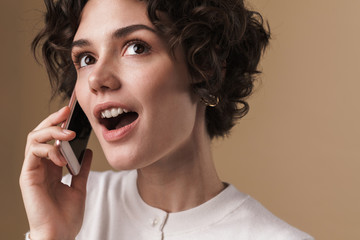 Image of cute beautiful woman posing and talking on cellphone