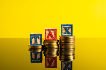 Coins stacking with letter TAX