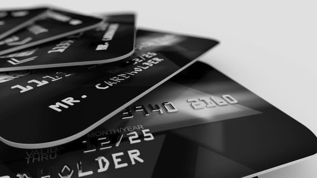 Optical art 3d rendering of black banking credit cards with stripes of digits in a black and grey palette placed like cards on a table in the white studio. Seamless loop.