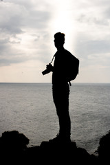 Silhouette of a photographer in front of the sea