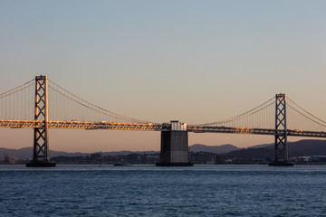 A tranquil twilight settles over the Bay Bridge that connects Oakland to San Francisco in California. This west coast urban area, including Oakland and San Jose, is home to about 8 million people.