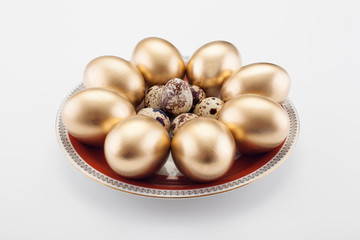 Pattern of Golden eggs and quail, on a white background. Easter concept, a symbol of the holiday.