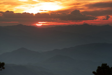 Sun over mountain range in twilight time