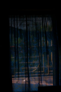 Spooky image of a blue window curtain. Halloween pictures.
