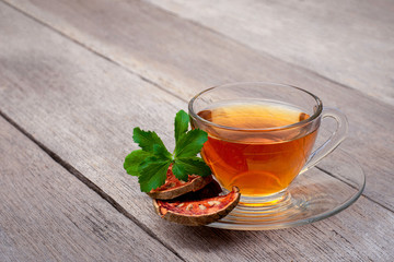 Bael fruit juice or quince tea with stevia leaves isolated on old rustic wood table background. Herbal tea and sugar free concept. 