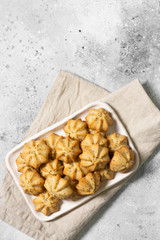 Shortbread with poppy seeds in a white ceramic plate on the gray kitchen table. Shortbread. Space for text