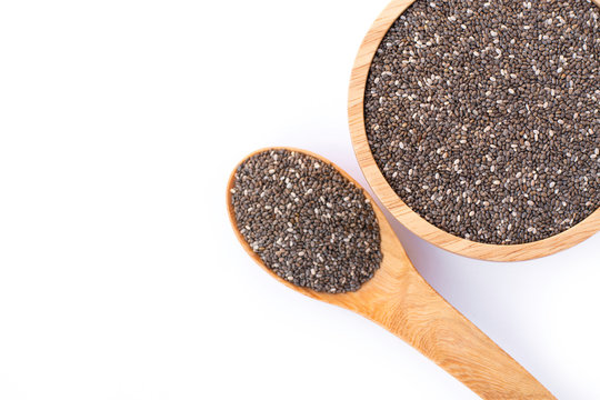 Chia seeds ( Salvia hispanica ) in wooden bowl and spoon isolated on white background. Healthy food or superfood and supplement concept. Top view. Flat lay.