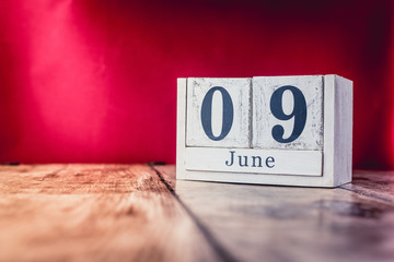 June 9th. Day 9 of month, calendar on business office table, workplace with vivid maroon red...