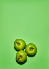 Apple on green background. Flat lay, top view, copy space . Food dietary concept.