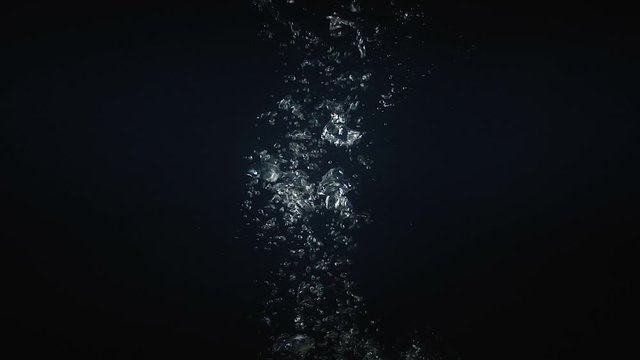 Shooting of falling mango in the water on black background