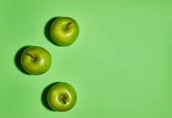 Apple on green background. Flat lay, top view, copy space . Food dietary concept.