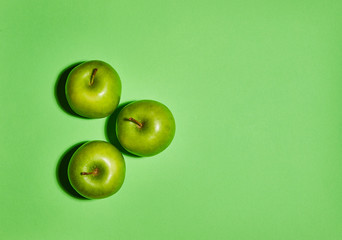Apple on green background. Flat lay, top view, copy space . Food dietary concept.