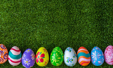 Easter holiday concept,Colorful Easter eggs line up green grass background with space.