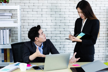 Company executive Young Asian businessman and coaching personal secretary assistant businesswoman partners while working together with laptop computer and strategy in business profit in office.