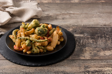 Japanese vegetable tempura on black plate. Copy space