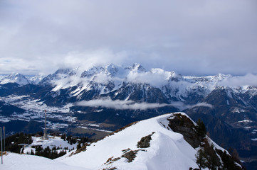 alps in winter at a  cold day with low clouds and nice view
