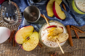 Apple cider sour card cocktail. Autumn Egg Flip alcohol beverage in shot glasses