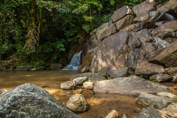 Kathu Waterfall in the tropical forest area In Asia, suitable for walks, nature walks and hiking, adventure photography Of the national park Phuket Thailand,Suitable for travel and leisure.