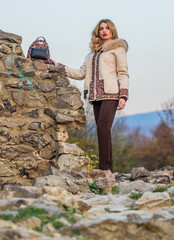 Relaxing on the wild side. sexy woman red lipstick nature background. autumn season clothes and accessory. woman leopard pattern half-length coat. warm short faux fur coat in fall