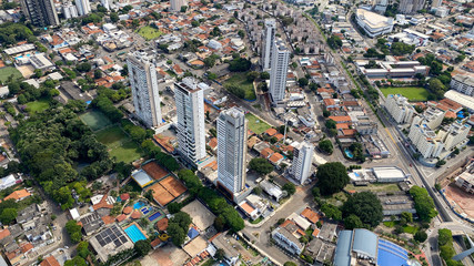 Naklejka premium Aerial view of residential buildings and green areas with native trees in Goiania, Goias, Brazil