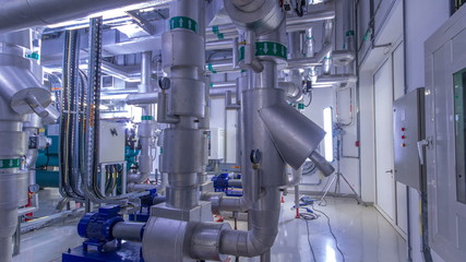 Equipment, cables and piping as found inside of industrial chiller plant room timelapse