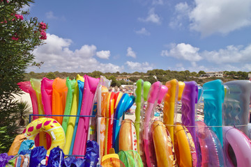 Colorful inflatable mattresses standing side by side