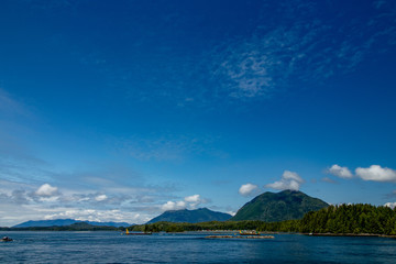 Beautiful clouds, sky and mountains seen from Tofino harbor - Tofino, Vancouver Island, BC, Canada