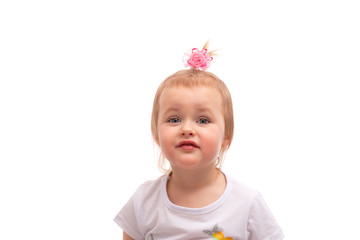 Shot of a cute  little girl with pink bow in her blonde hair and blue eyes, isolated