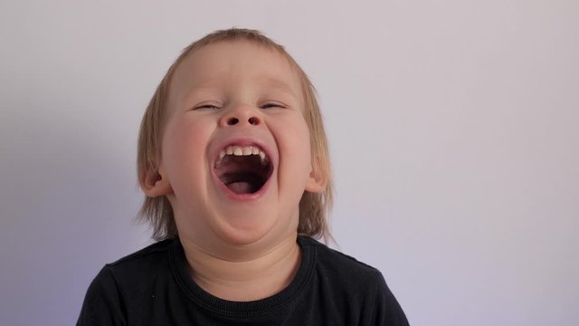 Close up tired little cute baby feeling boring portrait of yawn European boy having tiredness