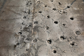 Pattern of Boring holes in old ground road by drilling rig machine. industrial concrete drilling at construction demolition work. Site main road Bangkok Thailand.