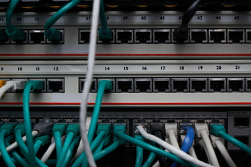 Inside of a server room. A lot of different cables in connectors. Equipment service in datacenter.