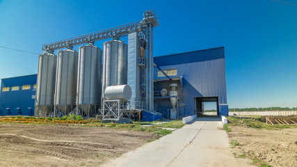 Fototapeta na wymiar Modern large granary timelapse . Large metal silos.