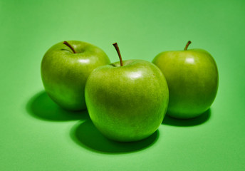 Apple on green background. Flat lay, top view, copy space . Food dietary concept.