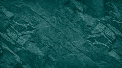 Green blue grunge background. Teal stone background. Toned rocky texture. Close-up. Underwater rocks texture background.