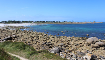 View of the rocky shoreline and lovely golden sand beach at La Greve Blanche, near Plouguerneau in Britttany in France.