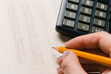 Accounting, financial concept, flat lay, calculator and pensil on wooden table