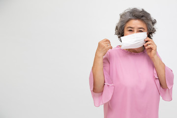 Asian senior woman wearing a protective face mask for plague coronavirus or covid-19 infectious disease. Facial hygienic mask for safety outdoor environmental awareness or virus spread concept